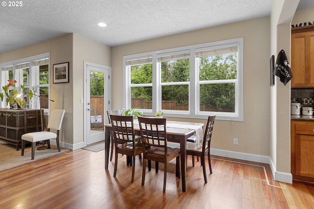 1613 SW Hume Ct, Portland, OR 97219 - dining room with light wood-style floors, a textured ceiling, baseboards, and recessed lighting