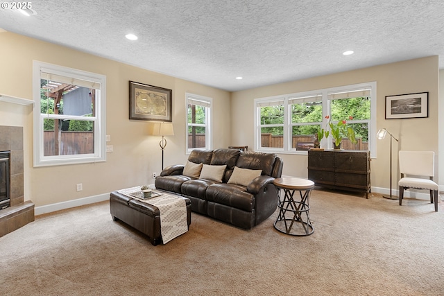 1613 SW Hume Ct, Portland, OR 97219 - living area featuring carpet floors, baseboards, a textured ceiling, recessed lighting, and a tile fireplace
