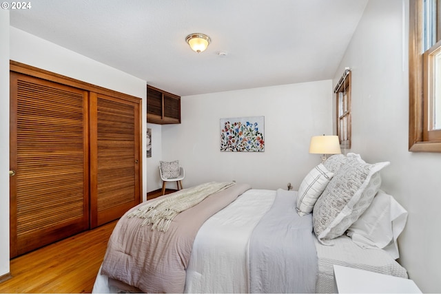 bedroom with a closet and light wood-style flooring