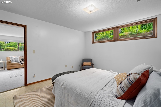 bedroom featuring a textured ceiling and baseboards