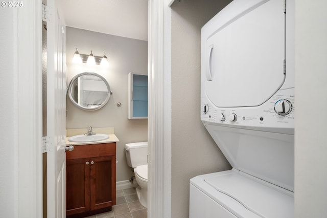 1910 SW 18th Ave Unit 34, Portland, OR 97201 - bathroom with estacked washer and dryer, vanity, and tile patterned flooring