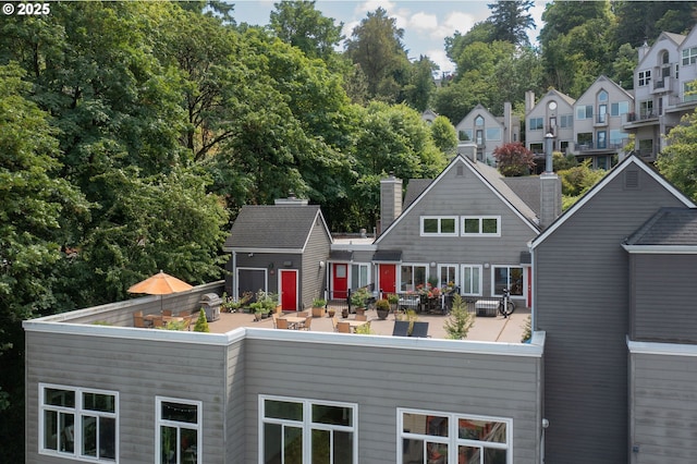 1910 SW 18th Ave Unit 34, Portland, OR 97201 - rear view of house featuring a storage shed and a chimney
