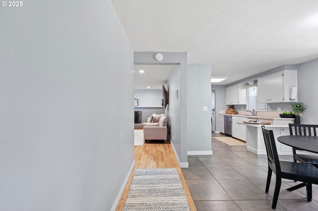 dining space with baseboards, washer / dryer, light tile patterned flooring, and recessed lighting