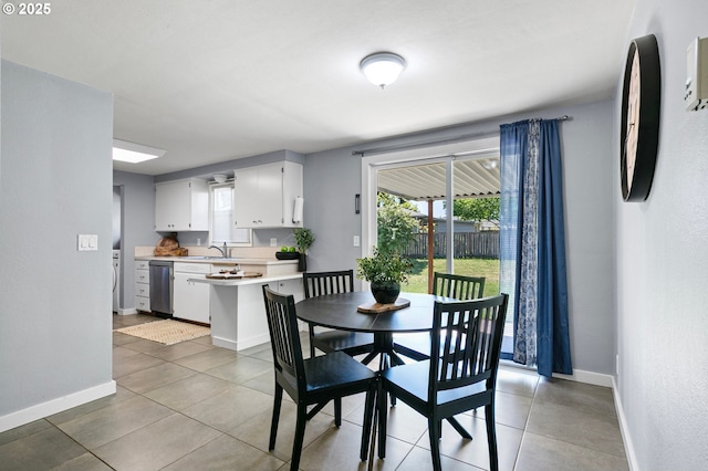 dining space featuring baseboards and light tile patterned floors
