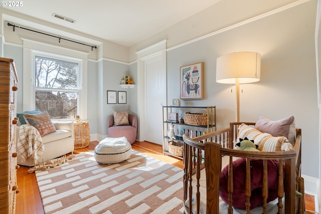 sitting room featuring light wood finished floors and visible vents