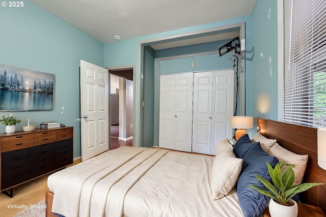 bedroom with wood-type flooring and a closet