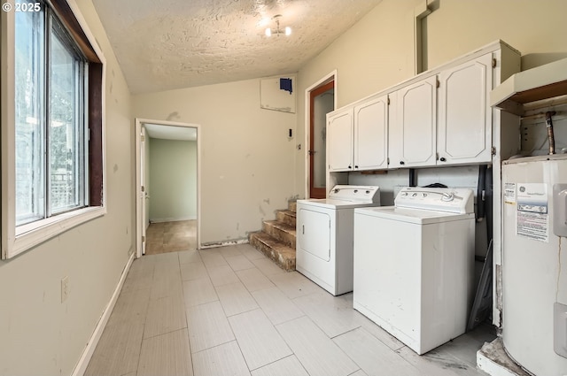 laundry room featuring cabinets, a textured ceiling, water heater, and washing machine and clothes dryer