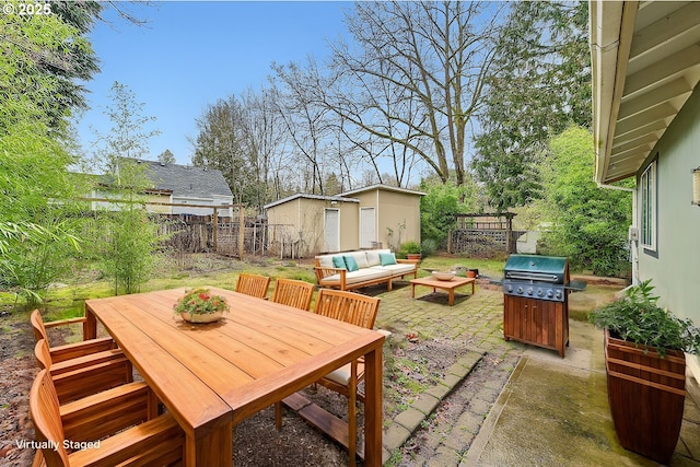 view of patio / terrace featuring an outdoor living space, a storage shed, and a grill