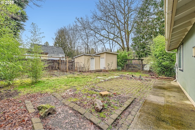 view of yard with a storage shed and a patio area