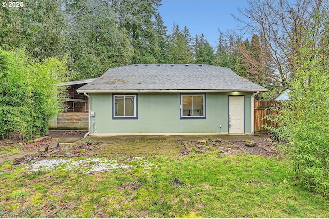 rear view of house featuring a lawn