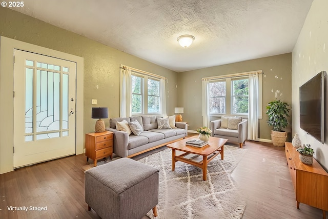 living room with plenty of natural light, hardwood / wood-style floors, and a textured ceiling