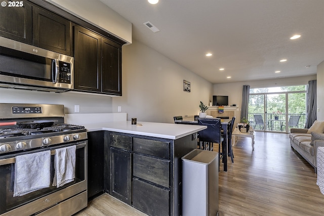 475 NE Liberty Ave, Gresham, OR 97030 - kitchen featuring stainless steel appliances, open floor plan, a peninsula, recessed lighting, and light wood finished floors