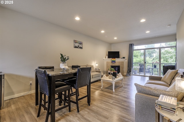 475 NE Liberty Ave, Gresham, OR 97030 - dining area with recessed lighting, light wood-style flooring, and a tile fireplace