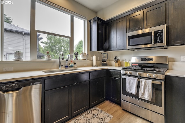 475 NE Liberty Ave, Gresham, OR 97030 - kitchen with appliances with stainless steel finishes, light countertops, and light wood-style flooring