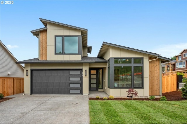 750 N V St, Washougal, WA 98671 - contemporary home featuring concrete driveway, a garage, and board and batten siding
