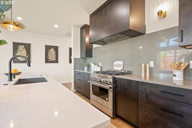750 N V St, Washougal, WA 98671 - kitchen with custom exhaust hood, high end stainless steel range oven, a sink, dark brown cabinetry, and recessed lighting