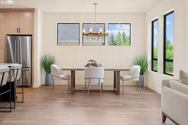 750 N V St, Washougal, WA 98671 - dining space with light wood-style flooring, healthy amount of natural light, baseboards, and a chandelier