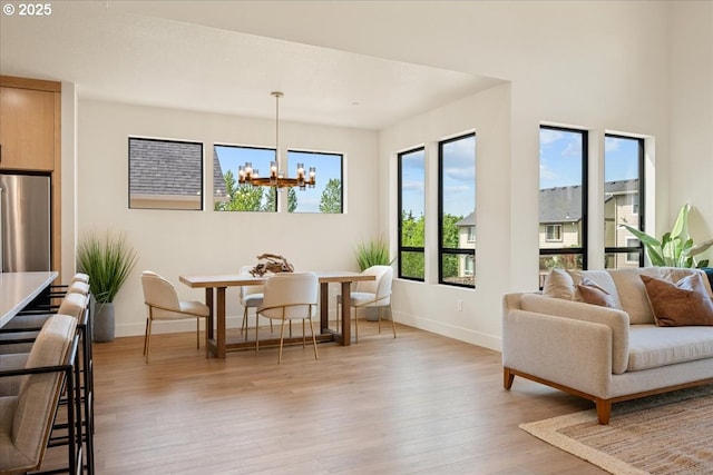 750 N V St, Washougal, WA 98671 - dining space with a chandelier, baseboards, and light wood-style floors
