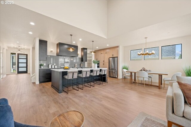 750 N V St, Washougal, WA 98671 - kitchen with freestanding refrigerator, a chandelier, modern cabinets, a breakfast bar area, and light countertops