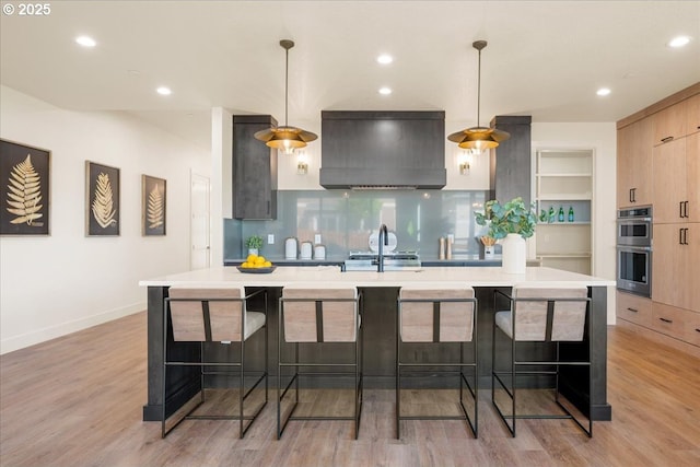 750 N V St, Washougal, WA 98671 - kitchen featuring custom exhaust hood, modern cabinets, light countertops, stainless steel double oven, and light wood-style floors