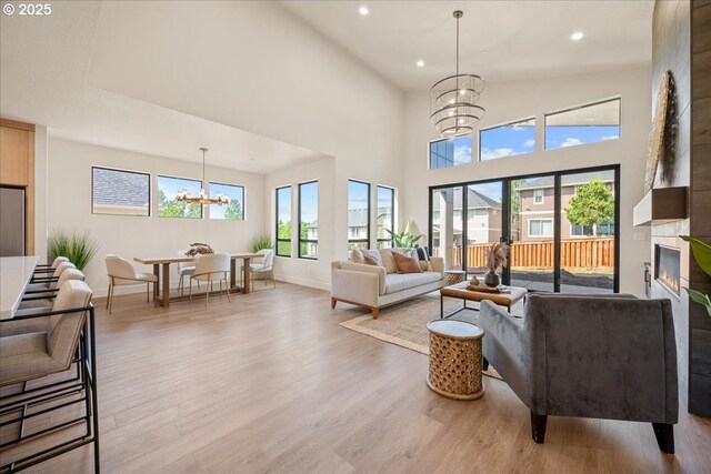 750 N V St, Washougal, WA 98671 - living room with a chandelier, wood finished floors, recessed lighting, healthy amount of natural light, and baseboards