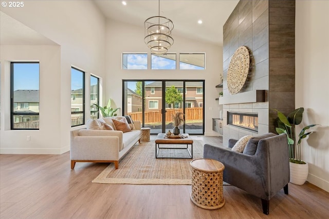 750 N V St, Washougal, WA 98671 - living area with wood finished floors, plenty of natural light, a fireplace, baseboards, and high vaulted ceiling