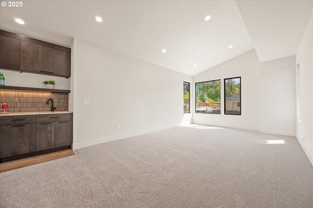 750 N V St, Washougal, WA 98671 - unfurnished living room featuring light carpet, baseboards, bar with sink, recessed lighting, and lofted ceiling