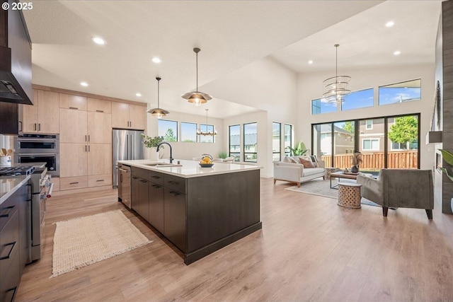 750 N V St, Washougal, WA 98671 - kitchen with light brown cabinets, a sink, appliances with stainless steel finishes, modern cabinets, and a chandelier