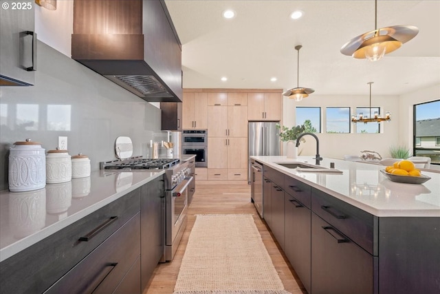 750 N V St, Washougal, WA 98671 - kitchen with stainless steel appliances, wall chimney range hood, a sink, recessed lighting, and modern cabinets