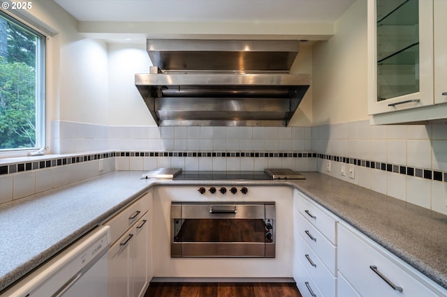 88771 Tokyo Ln, Bandon, OR 97411 - kitchen featuring exhaust hood, oven, dishwasher, white cabinetry, and glass insert cabinets