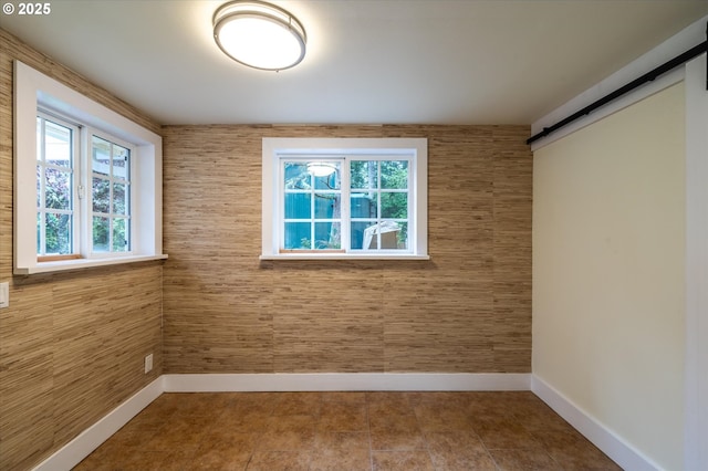 88771 Tokyo Ln, Bandon, OR 97411 - unfurnished room with a barn door and baseboards