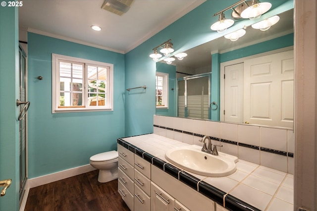 88771 Tokyo Ln, Bandon, OR 97411 - full bathroom with a shower stall, vanity, wood finished floors, crown molding, and backsplash