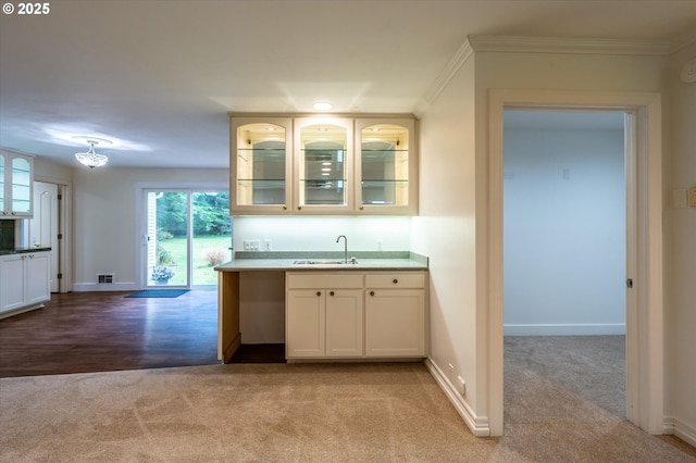 88771 Tokyo Ln, Bandon, OR 97411 - kitchen featuring light carpet, glass insert cabinets, ornamental molding, light countertops, and white cabinets