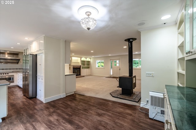 88771 Tokyo Ln, Bandon, OR 97411 - kitchen featuring freestanding refrigerator, ventilation hood, a glass covered fireplace, white cabinetry, and wall oven