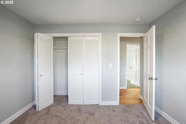 unfurnished bedroom featuring light carpet