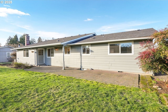 rear view of house featuring a lawn