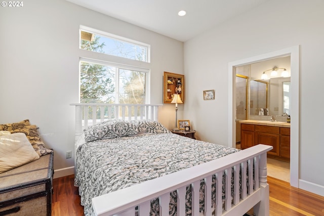 6904 SW Joshua Ct, Powell Butte, OR 97753 - bedroom featuring wood finished floors, ensuite bath, and recessed lighting