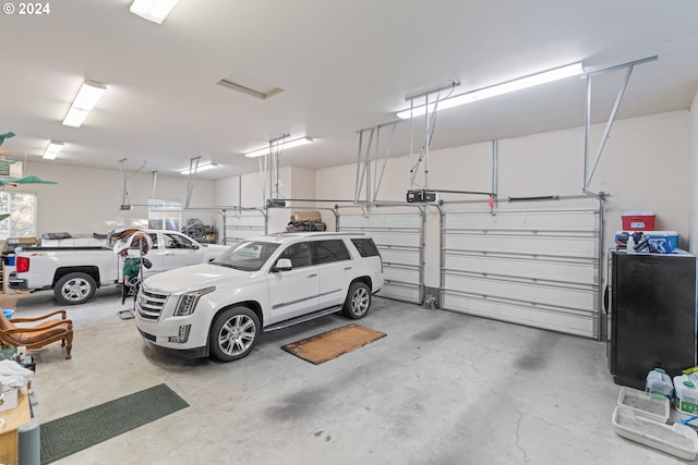 6904 SW Joshua Ct, Powell Butte, OR 97753 - garage featuring a garage door opener