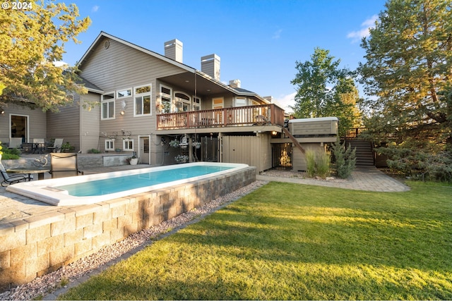 6904 SW Joshua Ct, Powell Butte, OR 97753 - rear view of house featuring stairs, a wooden deck, a chimney, and a lawn