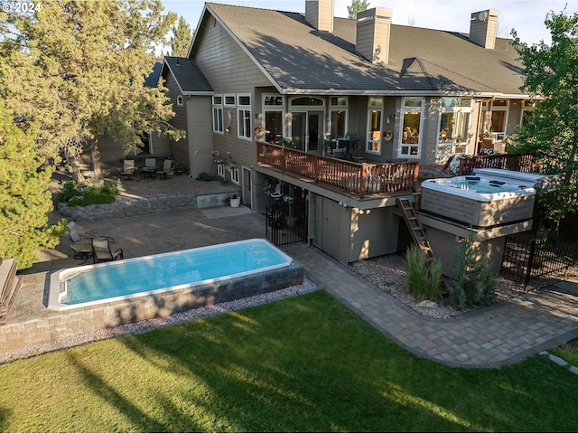6904 SW Joshua Ct, Powell Butte, OR 97753 - rear view of property with a chimney, a deck, a yard, a patio area, and an outdoor pool