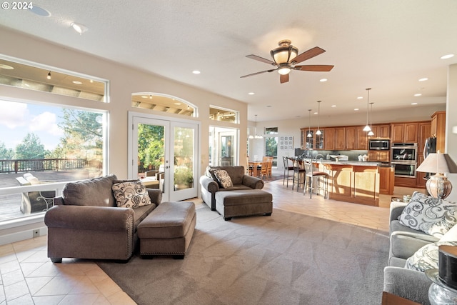 6904 SW Joshua Ct, Powell Butte, OR 97753 - living room with plenty of natural light, a ceiling fan, light tile patterned flooring, recessed lighting, and french doors