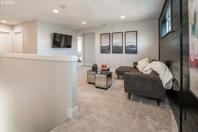 living room with recessed lighting, light colored carpet, plenty of natural light, and baseboards