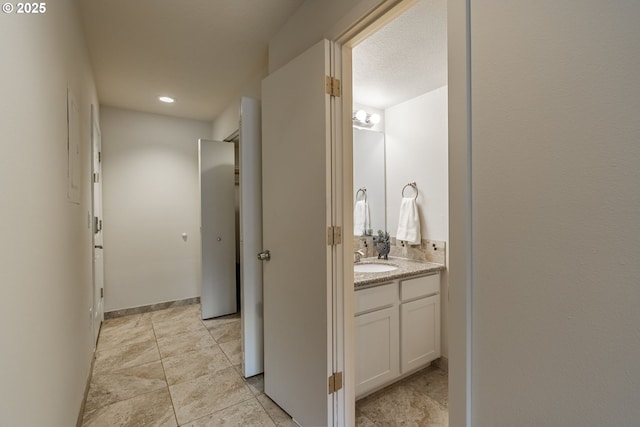 1745 NW Lakeway Ln, Beaverton, OR 97006 - corridor featuring a sink, baseboards, and recessed lighting