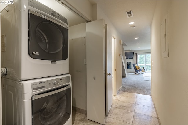 laundry area with visible vents, baseboards, laundry area, recessed lighting, and stacked washer and clothes dryer