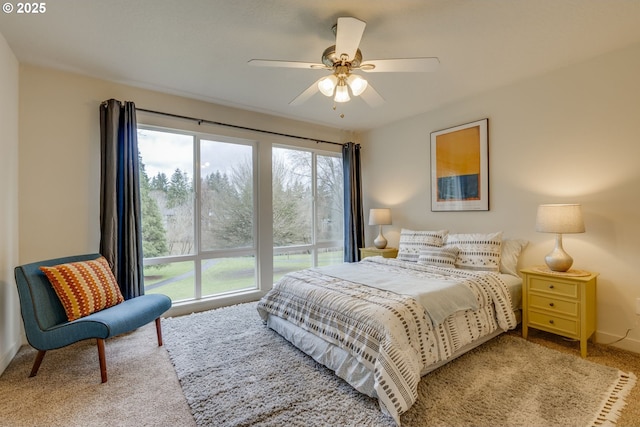 carpeted bedroom with a ceiling fan and baseboards