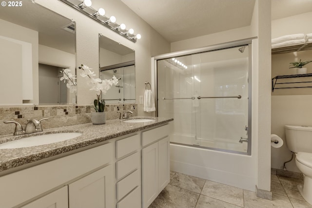 1745 NW Lakeway Ln, Beaverton, OR 97006 - bathroom with toilet, tile patterned flooring, double vanity, and combined bath / shower with glass door