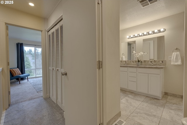 1745 NW Lakeway Ln, Beaverton, OR 97006 - corridor featuring a sink, baseboards, recessed lighting, and light carpet