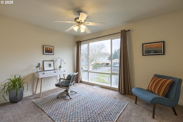 carpeted office space with baseboards and ceiling fan