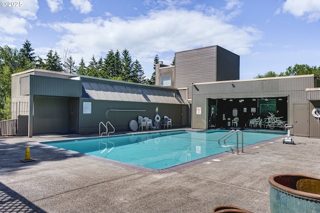 community pool with a patio and fence