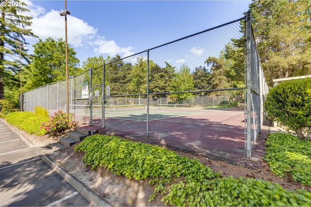 view of tennis court with fence